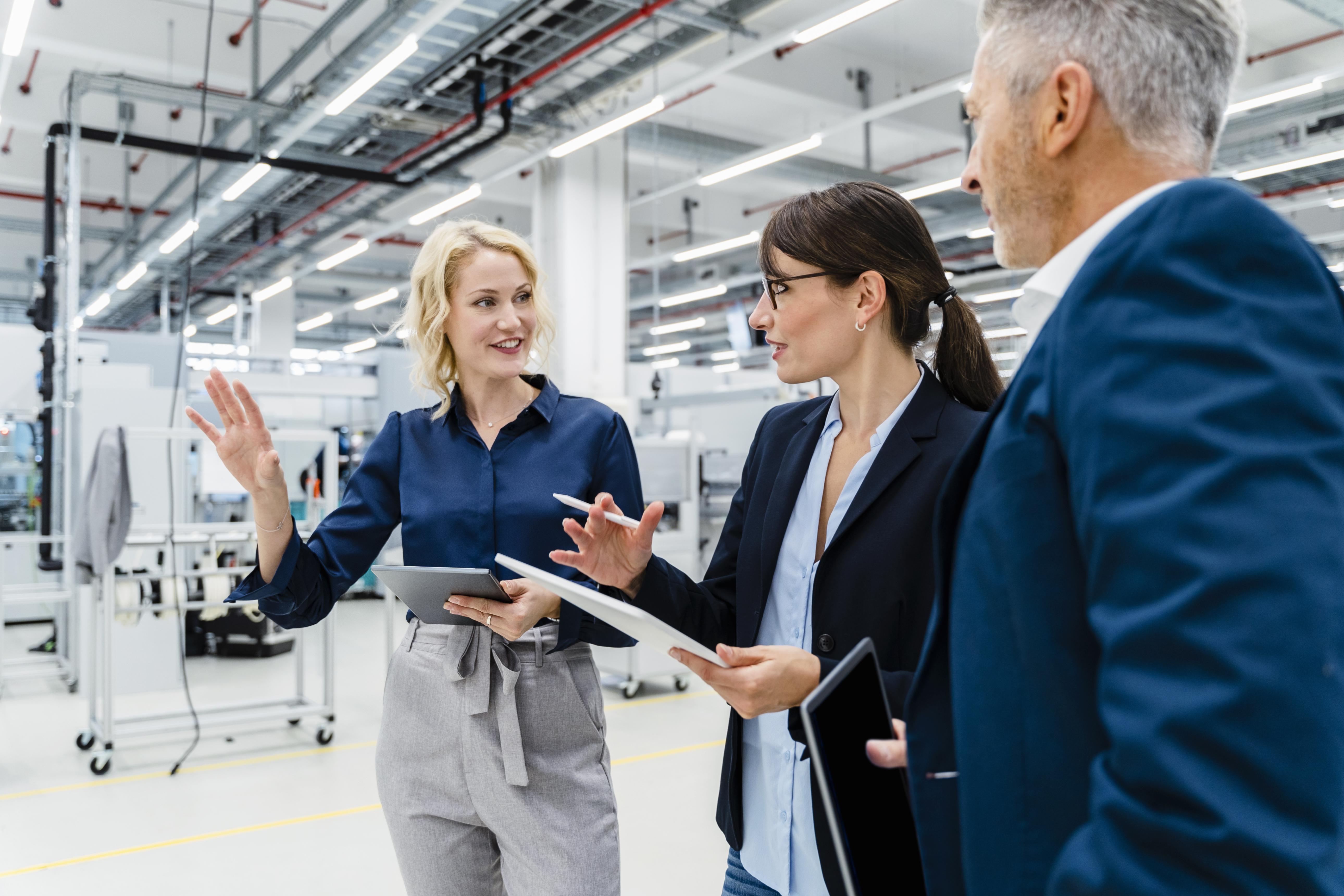 Executive reviewing equipment performance during a plant floor walkthrough