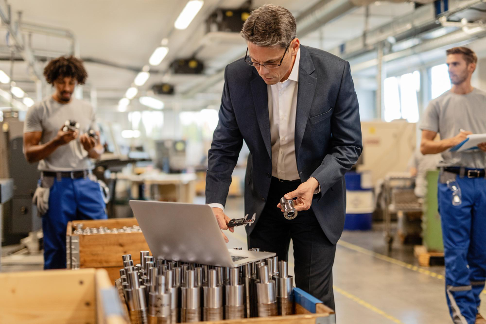Executives reviewing combined equipment and service capabilities on a plant floor